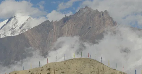 Drone pull out shot of prayer flags and sandy ridge in Mustang Nepal Stock Footage 336340037