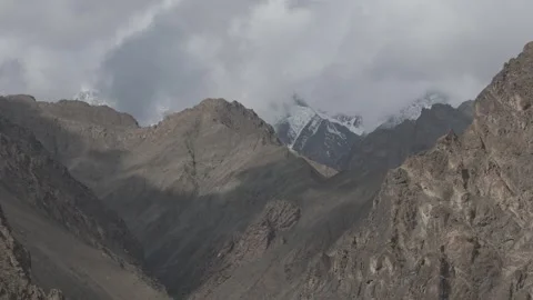 Drone Pull Out Through Dramatic Ladakh Mountain Valley with Snow Peaks with Stock Footage 335742914