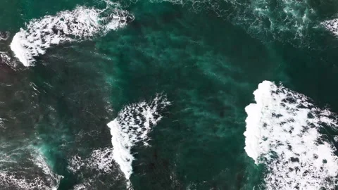 Drone pull up shot of large and powerful waves crashing down on the Stock Footage 263897809