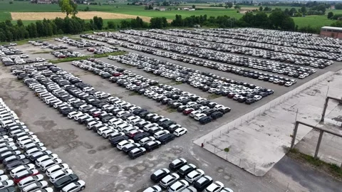Drone pullback above finished vehicle logistics compound in Po Valley near Stock Footage 340318178