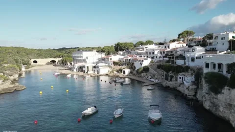 Drone pullback from Alcaufar cove revealing the fishing village, small boats Video stock 333009238