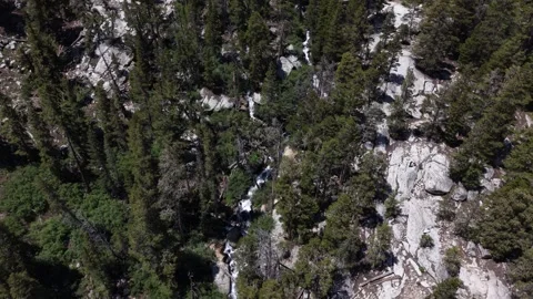 Drone Pullback from Alpine Waterfall Through Mountain Wilderness Stock Footage 338163750