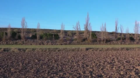 Drone Pullback and Rise Revealing Winter Plowed Farmland After Harvest Stock Footage 325223158