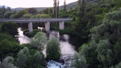 Drone Pullback from Bridge Revealing River and Trees in Blato na Cetini, Croatia Stock Footage 314746862