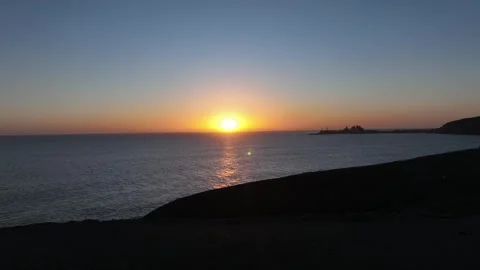 Drone Pullback from Calm Ocean to Dark Coastal Land – Gran Canaria at Dusk Stock Footage 309940523