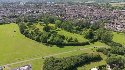Drone pullback from crescent tree line over Chad Park, Chadwell Heath, London Stock Footage 337799352