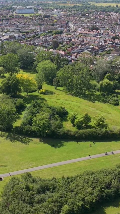Drone pullback from crescent tree line over Chad Park, Chadwell Heath, London Stock Footage 337799401