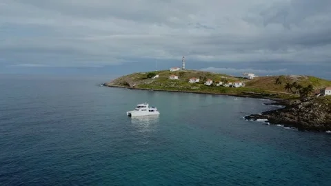 Drone pullback from dive catamaran toward Farol de Abrolhos on Santa Bárbara Video stock 334040396