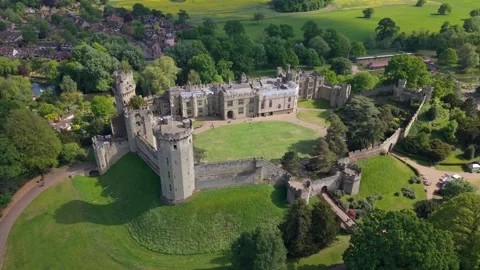 Drone Pullback Footage of Castle Dungeon in Warwick with Green-Yellow Meadows Stock Footage 331237022