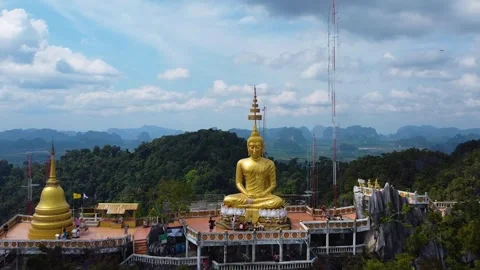 Drone Pullback from Golden Buddha Statue at Wat Tham Suea Stock Footage 331224711