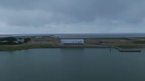 Drone pullback from modern visitor center on the Afsluitdijk Stock Footage 343839267