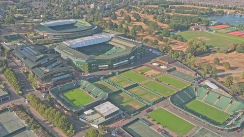 Drone Pullback over All England Club Courts with Wimbledon Park Lake Beyond 動画素材 348622711