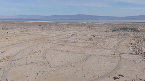 Drone Pullback Over Empty Street Grid in Salton City with Salton Sea Stock-Footage 332682686