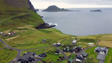 Drone pullback over Gasadalur aerial view of houses, rocks, Faroe Islands Stock Footage 314920655