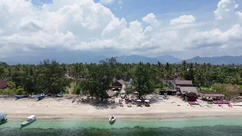 Drone Pullback Over Gili Air Beach with Turquoise Water and Palm Trees Stock Footage 321150162