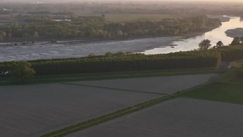 Drone pullback over Po River floodplain fields and riparian forest near Cremona Video stock 334358763