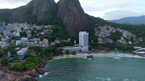 Drone pullback over Praia do Vidigal and Sheraton Grand Rio Hotel Morro Dois 動画素材 334114333