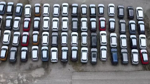 Drone pullback with parallax above finished crossover SUV logistics compound Vídeo Stock 339752638