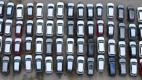 Drone pullback with parallax above finished crossover SUV storage rows Vídeo Stock 339752645