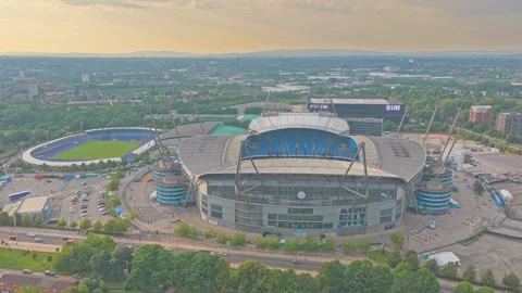 Drone pullback revealing Etihad Stadium and Sportcity sports complex at golden Stock Footage 341902761