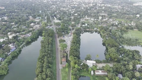 Drone Pullback Revealing Historic Jagati Railway Station and Green Landscape Stock Footage 344089056