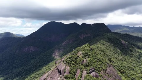 Drone Pullback Revealing a Massive Rock Mountain Beyond Dak Lak Stock Footage 343806825