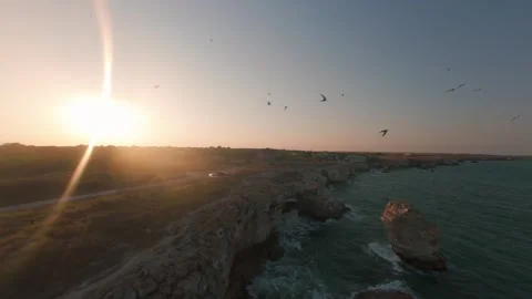 Drone pullback revealing natural sea arch and seabirds at sunset in Tyulenovo. Stock Footage 342137536