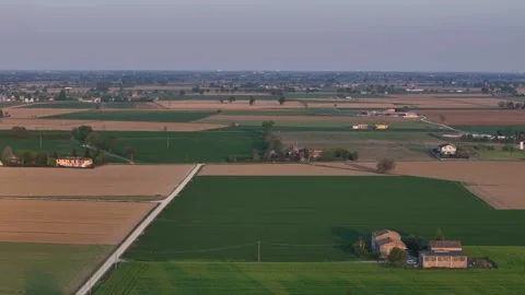 Drone pullback revealing patchwork farmland across the Po Valley plain Stock Footage 340155708