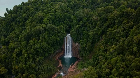 Drone Pullback Revealing Remote Tropical Waterfall in Karawawi Kaimana, Papua Stock Footage 334920299