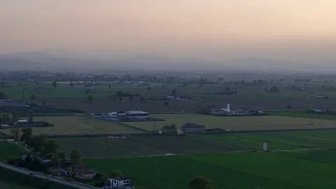 Drone pullback revealing solar farm along Via Emilia in Po Valley farmland Italy Video stock 334359980