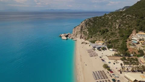 Drone Pullback Revealing Stunning Turquoise Coastline and Mountain Beach Stock-Footage 336514598