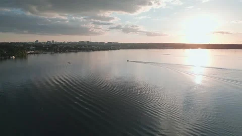 Drone pullback revealing wakeboarding on Lake Paranoa at sunset in Brasilia Stock-Footage 342475103