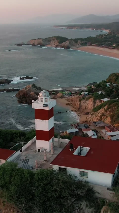 Drone pullback reveals Faro de Bucerias lighthouse, rocky coast, El Faro and La Stock-Footage 337143192