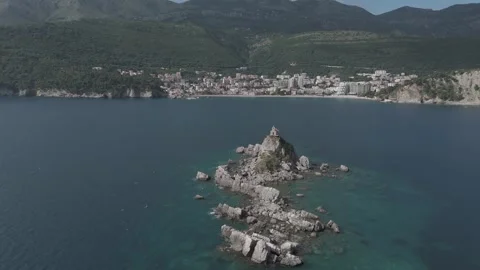 Drone Pullback from Saint Nedjelja Islet Revealing Petrovac Coastline, Montenegr Stock-Footage 310335306