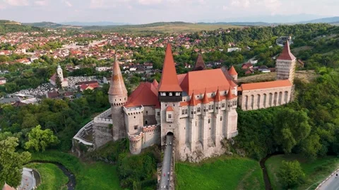Drone pullback shot of Corvin Castle revealing surrounding Stock-Footage 282375288