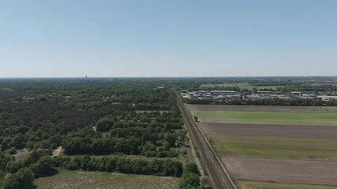 Drone Pullback Shot of Rural Railway Through Lush Green Countryside Видео 310439715