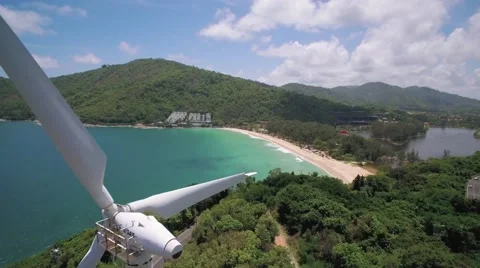 Drone Pullback Shot through Wind Turbine at Naiharn Beach Phuket Video stock 65808866