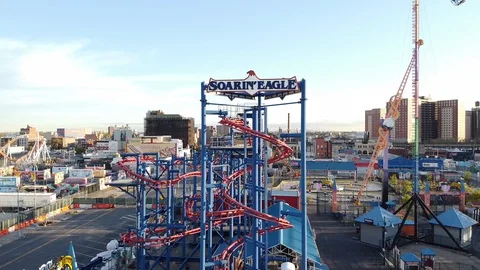 Drone pullback from Soaring Eagle Roller Coaster Luna Park Stock Footage 129761339