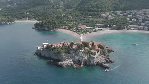Drone Pullback from Sveti Stefan Showing Coastline and Clear Water – Montenegro Stock Footage 310335369