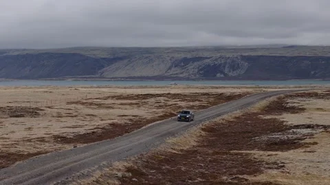 Drone pullback tracking a 4x4 along Route 42 beside Kleifarvatn in Southwest Stock Footage 342734452