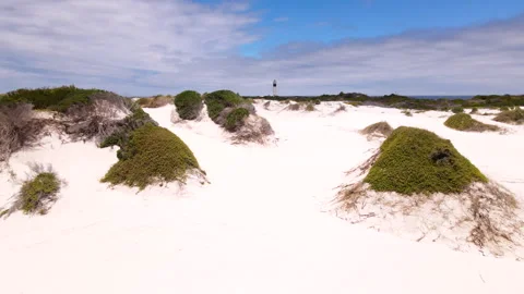 Drone pullback view over dunes and Moonlight beach of Cape Hangklip Lighthouse Stock Footage 331118196