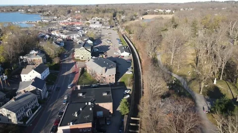 Drone pullback view of parking areas, harborside, roadways and commercial Stock Footage 190446035