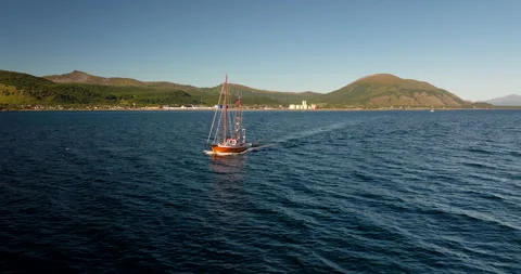Drone pullback view of sailboat cruising in Lofoten islands, arctic Norway Stock Footage 331755057