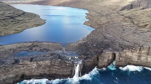Drone Pullback from Waterfall to Lake Sørvágsvatn – Faroe Islands Aerial View Stock Footage 313497007