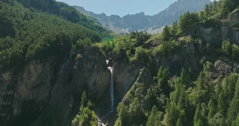 Drone Pullback from Wild Waterfall to Pine Forest and Granite Peaks in the Stock Footage 342345743