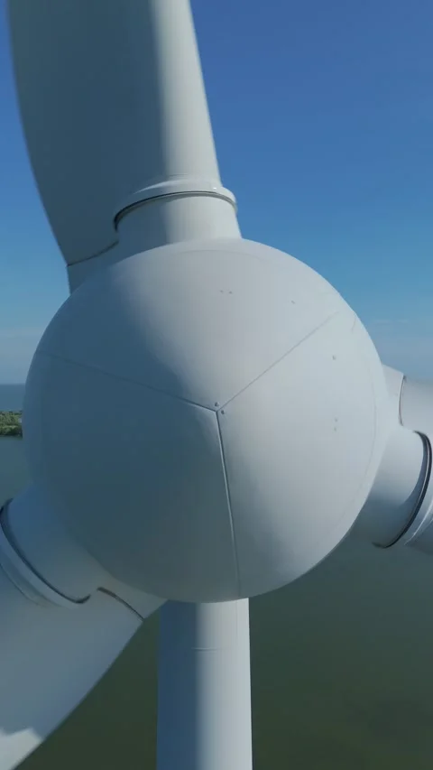 Drone pullback from wind turbine over water and dike landscape Stock Footage 339682064