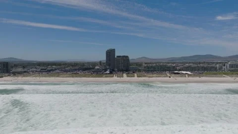 Drone pulling away from Blouberg beach during Red Bull kitesurfing event Stock Footage 313912873