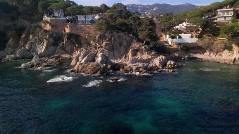 Drone Pulling Away from Pine Clad Rocky Coastline near Lloret de mar, Spain Stock Footage 306015615