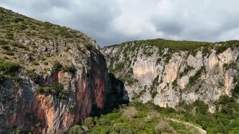 Drone Pulling Away from Scenic Mountain Canyon with Steep Rocky Cliffs Stock Footage 330882672