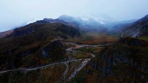 Drone Pulling Away From Snow-Capped Mountain With Cloudy Glaciers Stock Footage 343419575
